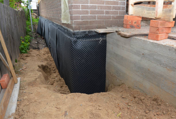 SJ Waterproofing Pros technician performing targeted Wet Basement Repair assessment in Auburn, MI